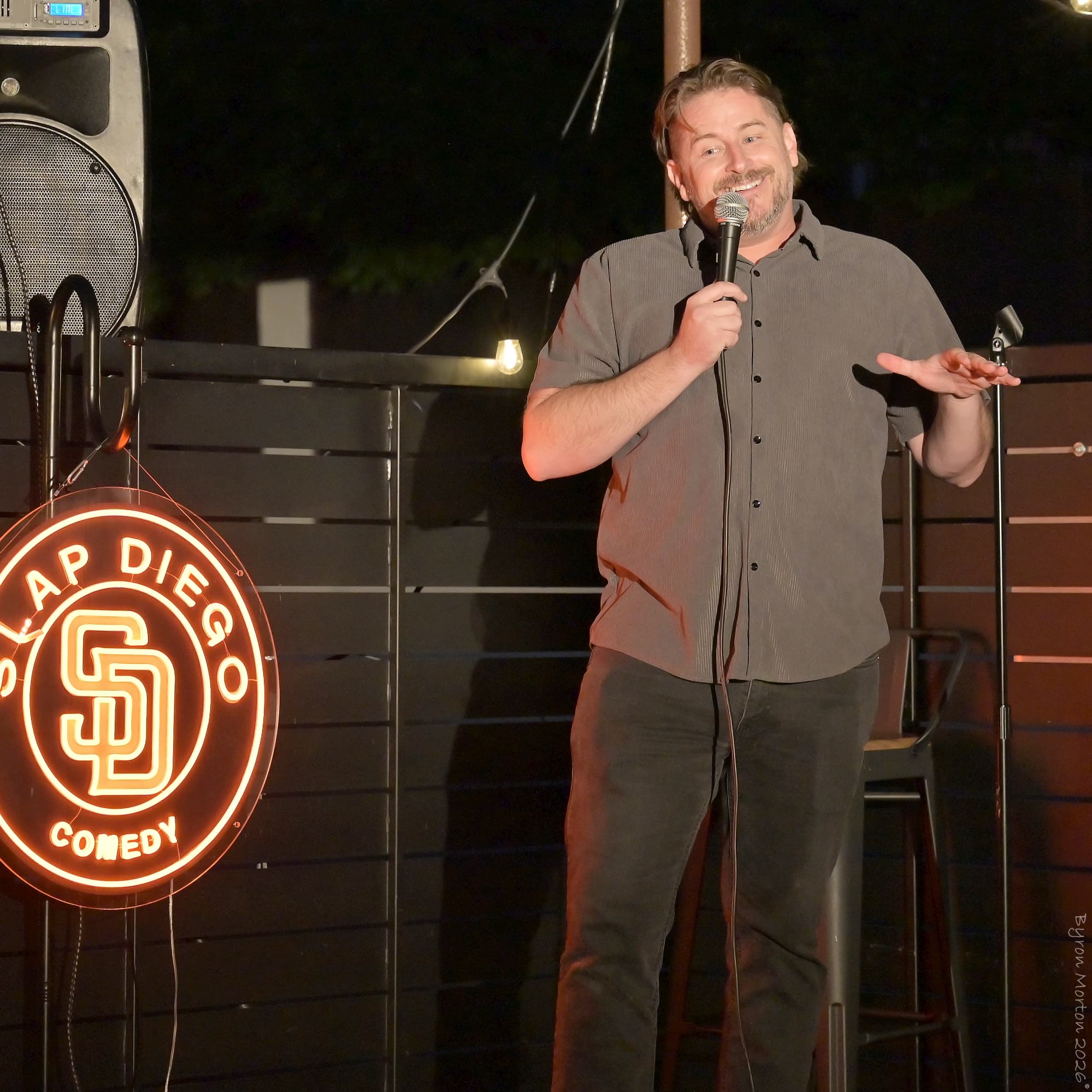 Scott Busby performing stand-up comedy on stage